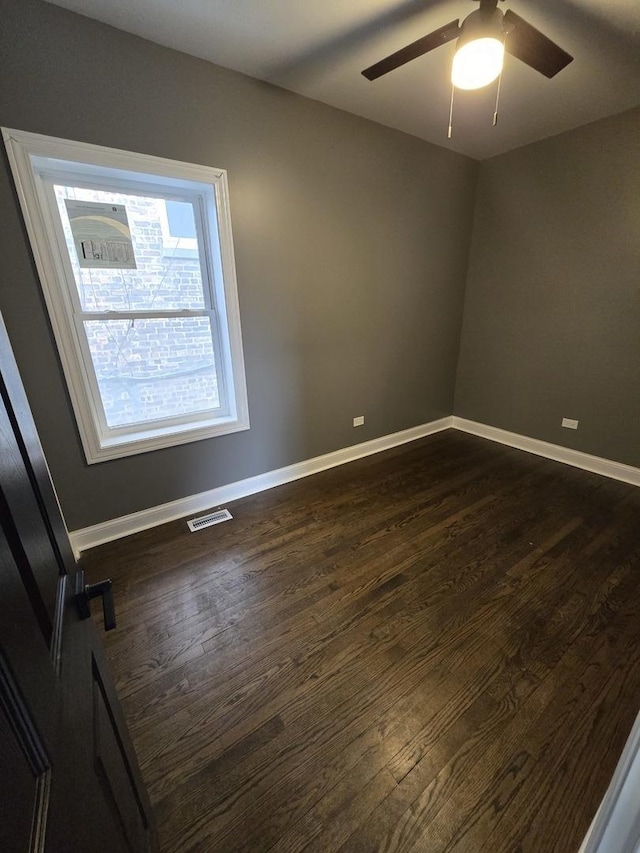 2040 W Garfield Blvd, Chicago, IL 60609 - unfurnished room featuring dark wood-style floors, visible vents, a ceiling fan, and baseboards