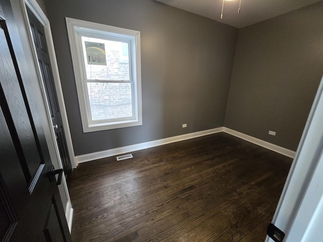 2040 W Garfield Blvd, Chicago, IL 60609 - empty room with visible vents, baseboards, and dark wood-type flooring