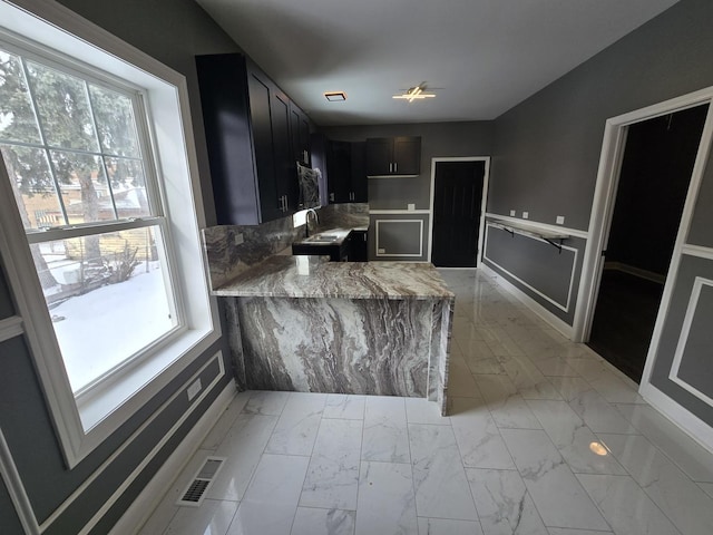 2040 W Garfield Blvd, Chicago, IL 60609 - kitchen with marble finish floor, a peninsula, and a healthy amount of sunlight