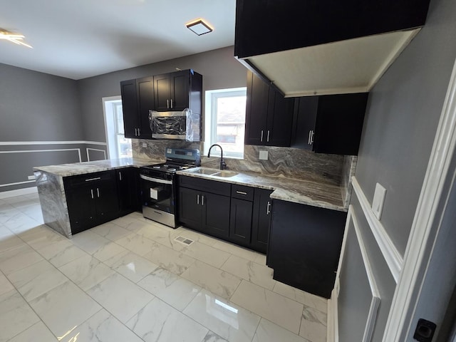 2040 W Garfield Blvd, Chicago, IL 60609 - kitchen with marble finish floor, a peninsula, stainless steel appliances, and dark cabinets