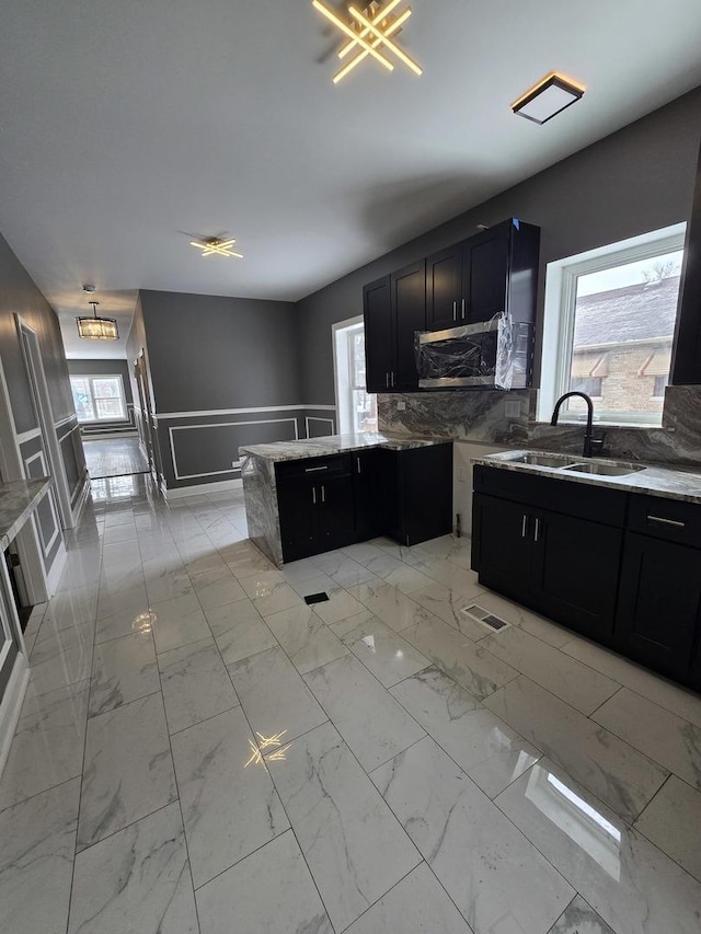 2040 W Garfield Blvd, Chicago, IL 60609 - kitchen with light stone counters, marble finish floor, and a sink