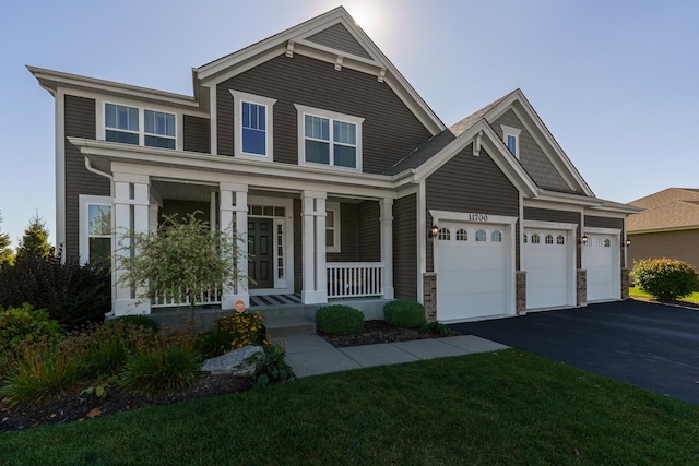 craftsman inspired home with driveway, a porch, and an attached garage