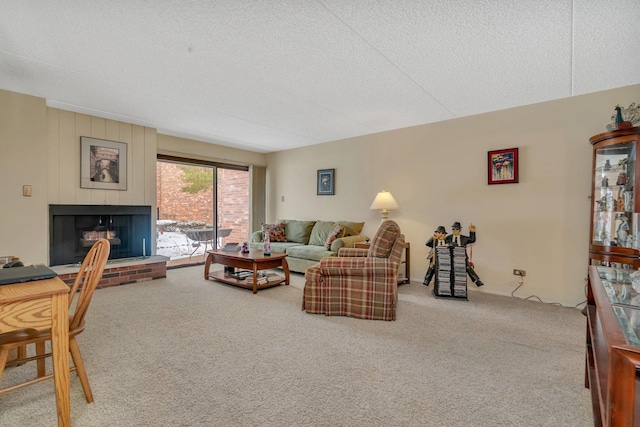 carpeted living room with a fireplace and a textured ceiling