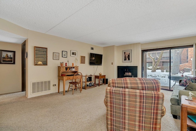 living room featuring light colored carpet and a textured ceiling