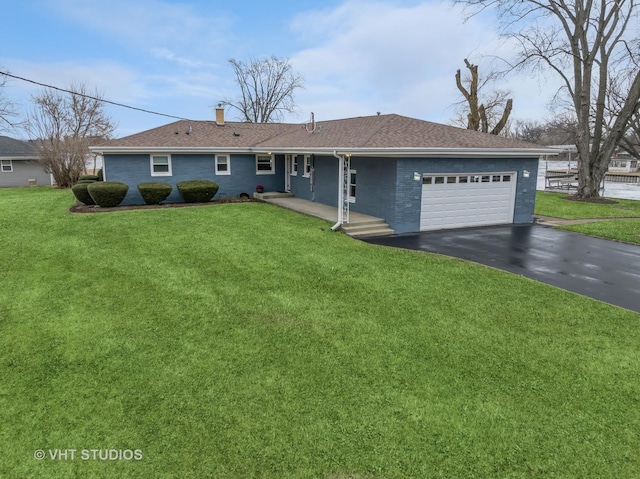 single story home with aphalt driveway, brick siding, a chimney, an attached garage, and a front yard