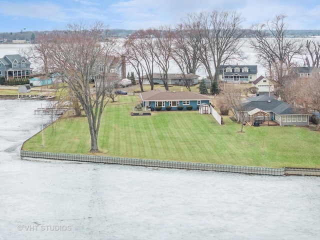 drone / aerial view with a residential view and a water view