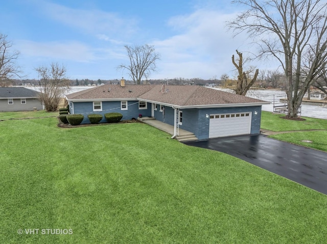 single story home with an attached garage, aphalt driveway, a chimney, and a front yard