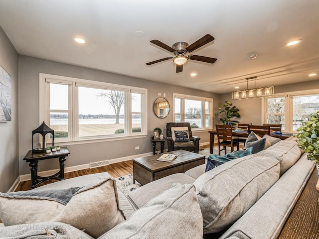 living room with recessed lighting, visible vents, ceiling fan, wood finished floors, and baseboards