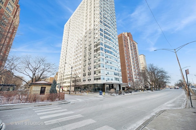 view of property with a view of city and fence