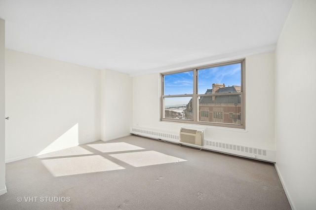 carpeted empty room featuring baseboards