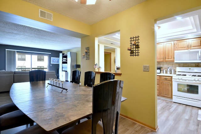 dining room with light hardwood / wood-style flooring