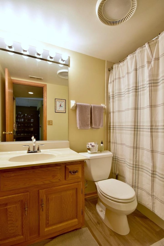 bathroom featuring vanity, hardwood / wood-style floors, and toilet