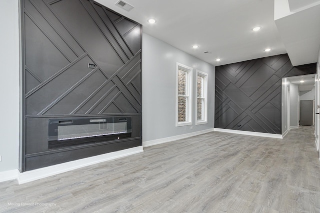 unfurnished living room featuring light hardwood / wood-style flooring