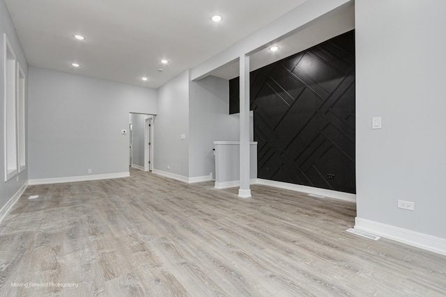 basement with light hardwood / wood-style floors