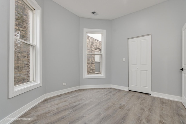 spare room featuring light hardwood / wood-style flooring