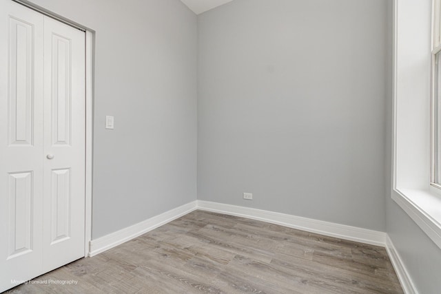 unfurnished room with light wood-type flooring