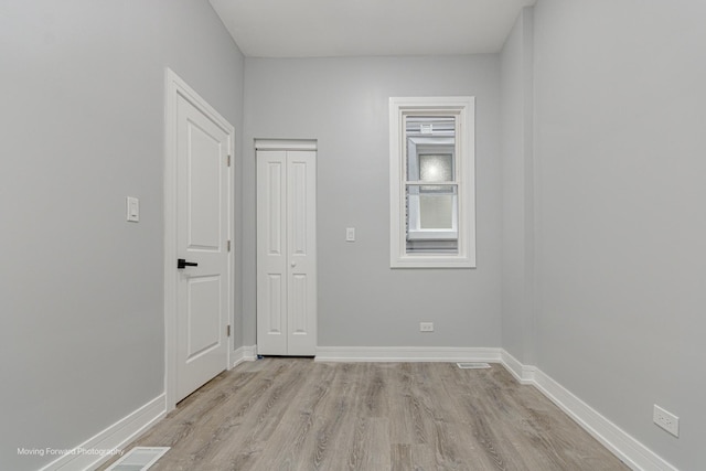 spare room featuring light hardwood / wood-style floors