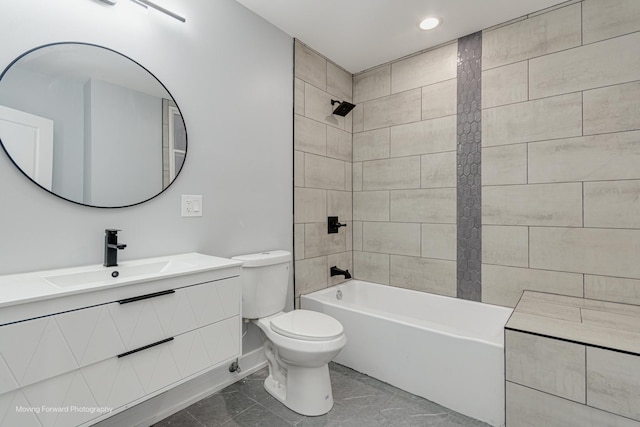 full bathroom with tiled shower / bath, vanity, and toilet