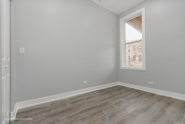 empty room with hardwood / wood-style flooring