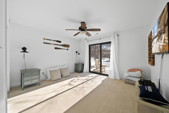 living area featuring carpet and ceiling fan