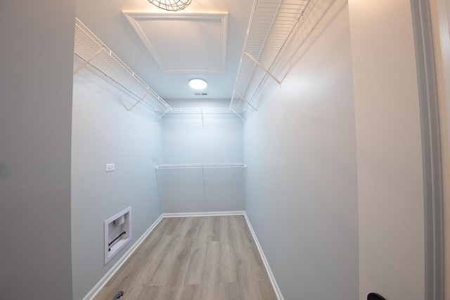 spacious closet with light hardwood / wood-style floors