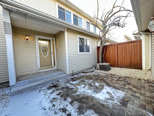 property entrance with central AC unit and a patio