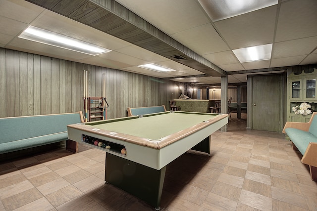 playroom with pool table, a drop ceiling, and wooden walls