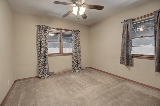 empty room with ceiling fan and carpet flooring