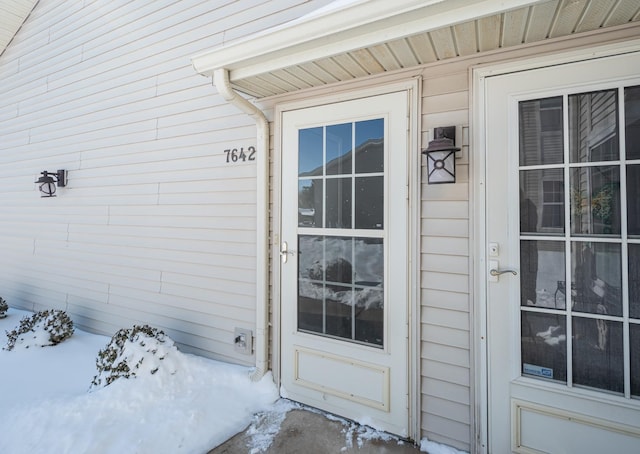 view of snow covered property entrance