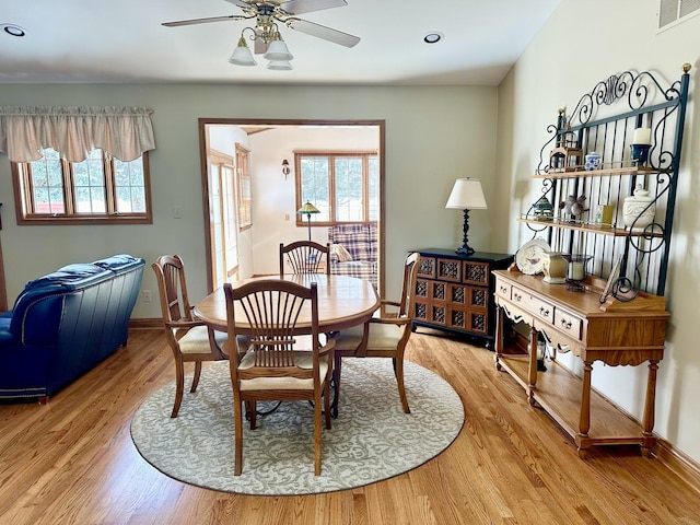 dining room with hardwood / wood-style floors, a wealth of natural light, and ceiling fan