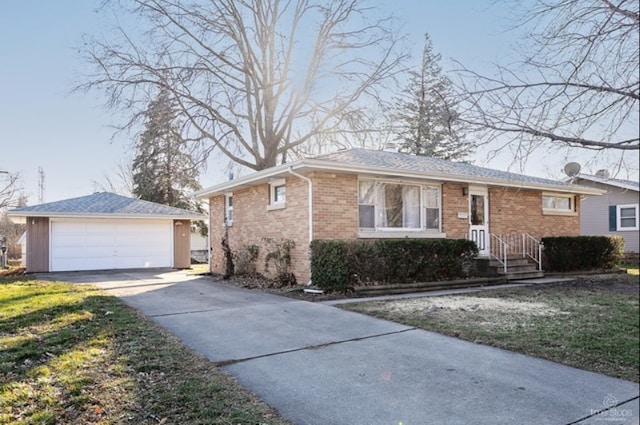 single story home featuring a front lawn, a garage, and an outbuilding