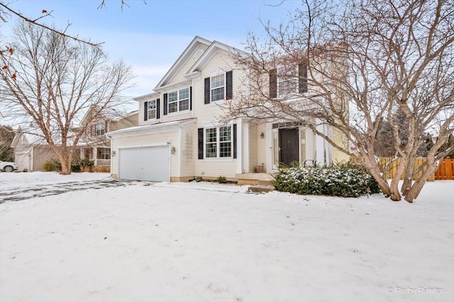 traditional home featuring fence and an attached garage