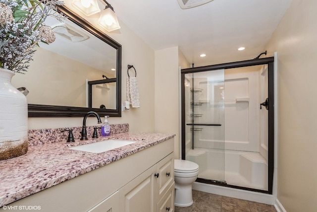 full bath featuring a shower stall, recessed lighting, vanity, and toilet