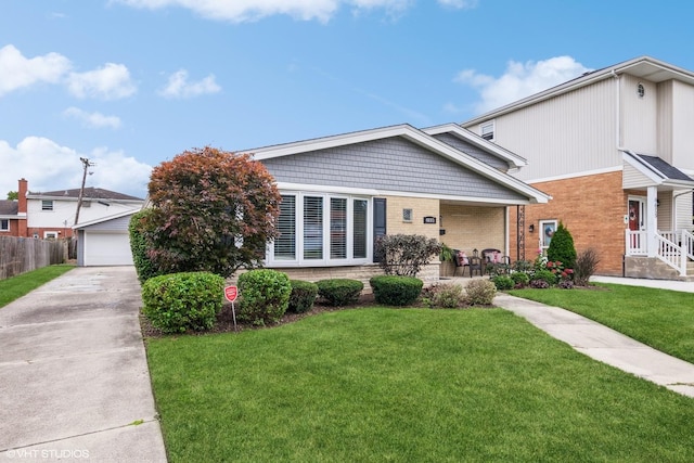 view of front facade with a garage, a front yard, and fence