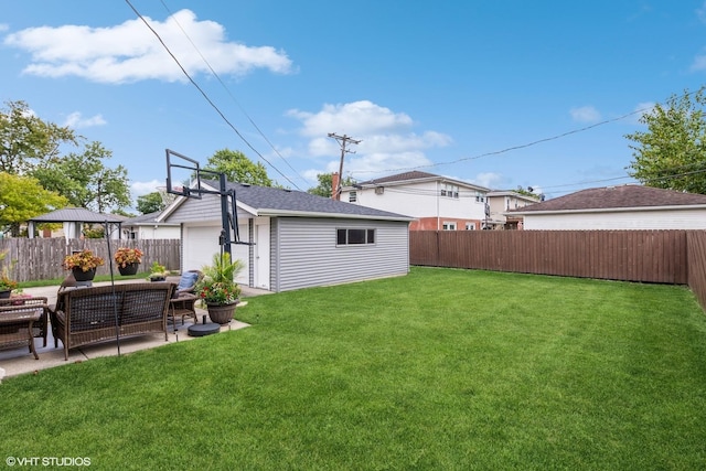 view of yard featuring a garage, a patio, a fenced backyard, and an outdoor structure