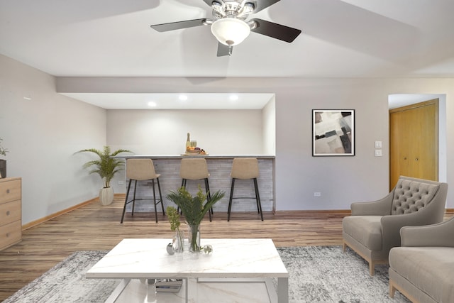 living room featuring bar area and hardwood / wood-style floors