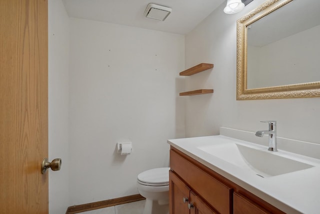 bathroom with tile patterned flooring, vanity, and toilet