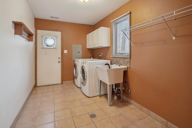 laundry room with cabinets, light tile patterned flooring, separate washer and dryer, and electric panel