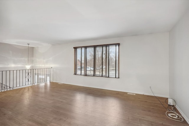 empty room with hardwood / wood-style flooring