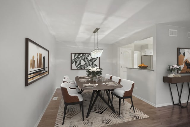 dining area with dark wood-type flooring