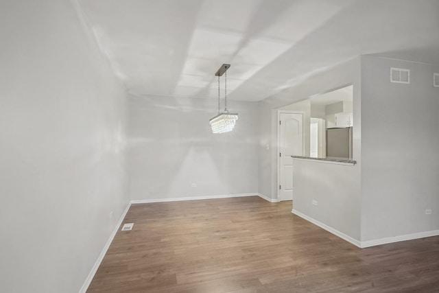 unfurnished dining area with hardwood / wood-style floors