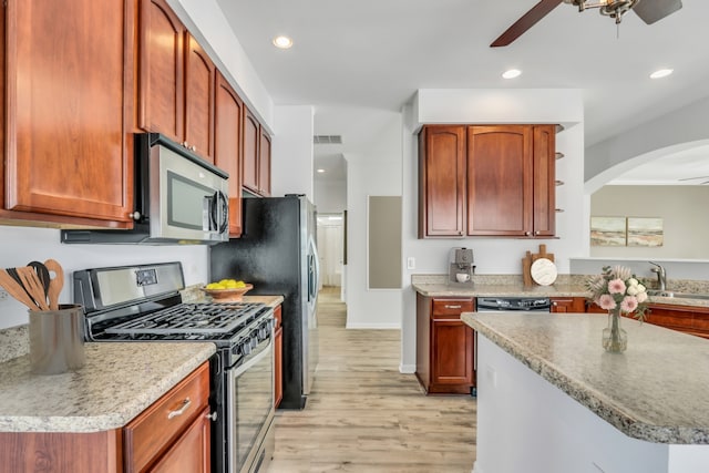 kitchen featuring appliances with stainless steel finishes, light countertops, ceiling fan, and open shelves