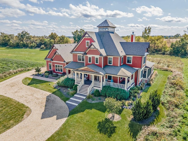 view of front of house with a porch and a front lawn