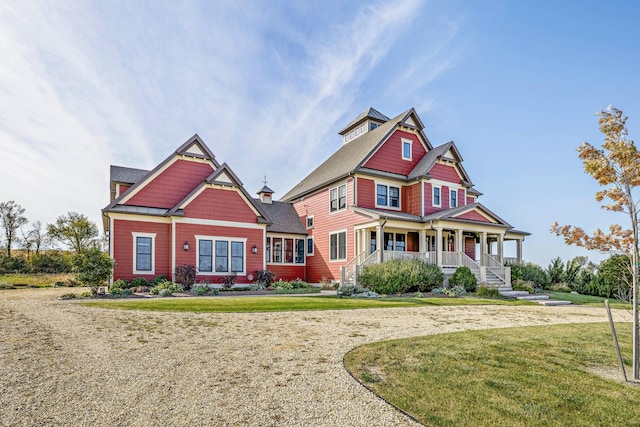 craftsman-style house featuring a porch and a front yard