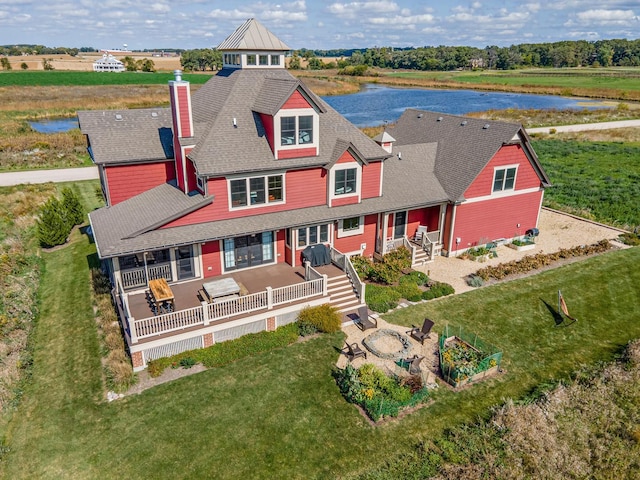 view of front facade with a patio, a water view, outdoor lounge area, and a front lawn