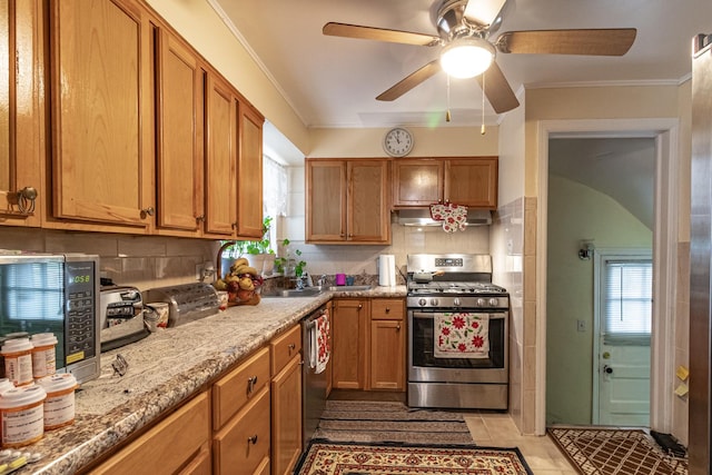 kitchen featuring backsplash, appliances with stainless steel finishes, ornamental molding, light stone countertops, and under cabinet range hood