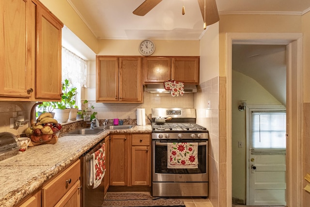 kitchen with decorative backsplash, appliances with stainless steel finishes, ventilation hood, and a sink