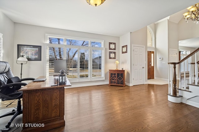 home office with a notable chandelier, baseboards, and wood finished floors