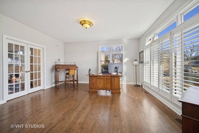 unfurnished office with french doors, baseboards, and dark wood-style floors