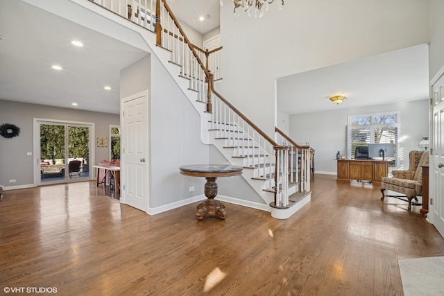 entryway featuring stairs, plenty of natural light, wood finished floors, and baseboards